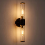 Double Bulb Clear Glass Tube Wall Light glowing on a plaster wall at night