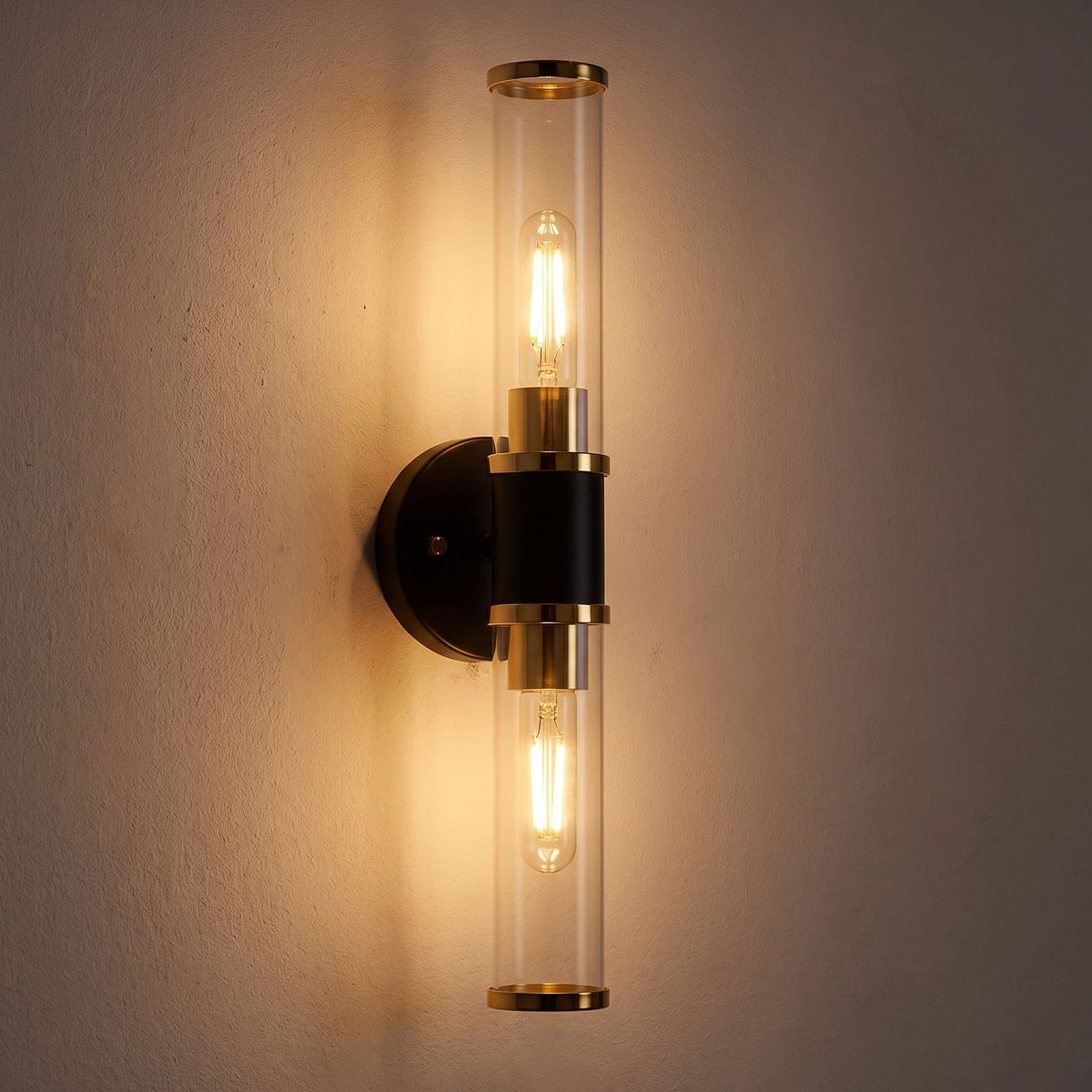Double Bulb Clear Glass Tube Wall Light glowing on a plaster wall at night