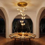 Double Ceramic Trumpet Cluster Chandelier above a round dining table at night