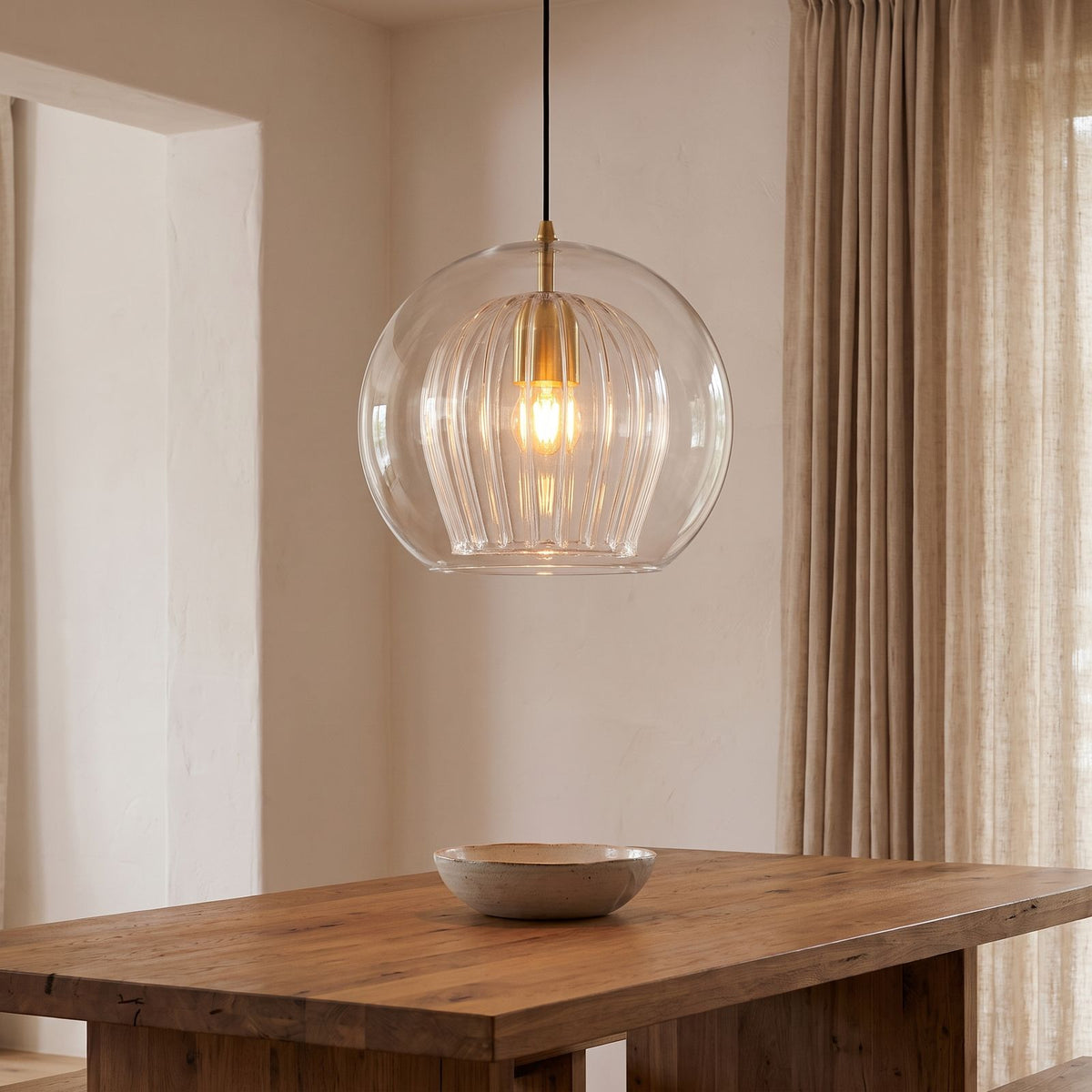 Double Glass Fluted Dome Pendant Light above a dining table