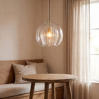 Double glass fluted dome pendant light over a breakfast nook table