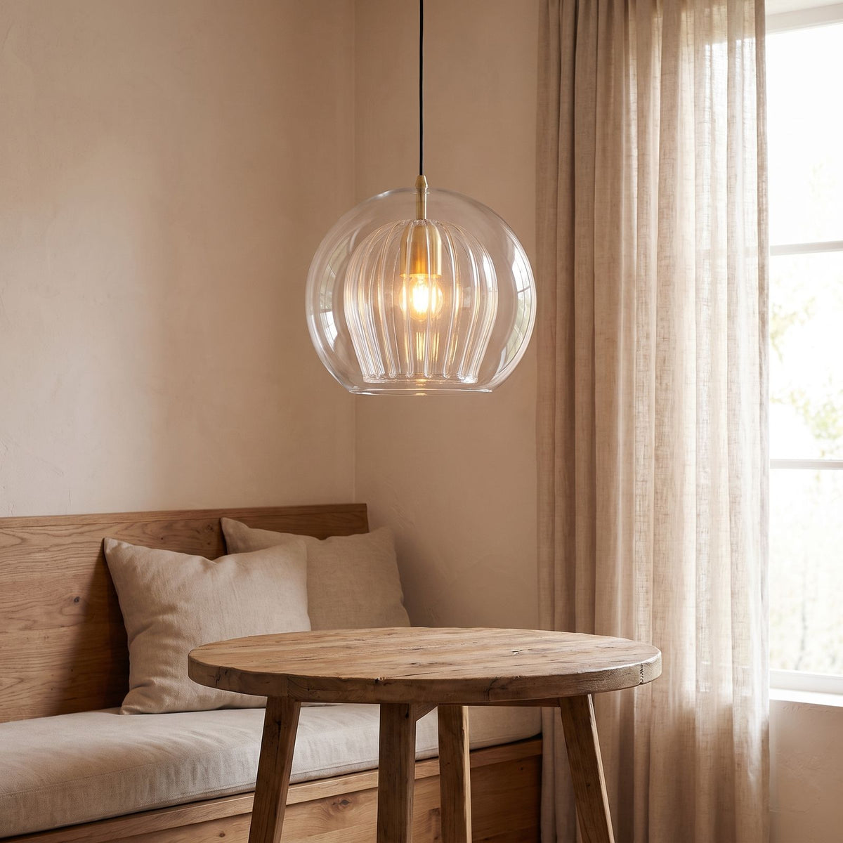 Double glass fluted dome pendant light over a breakfast nook table