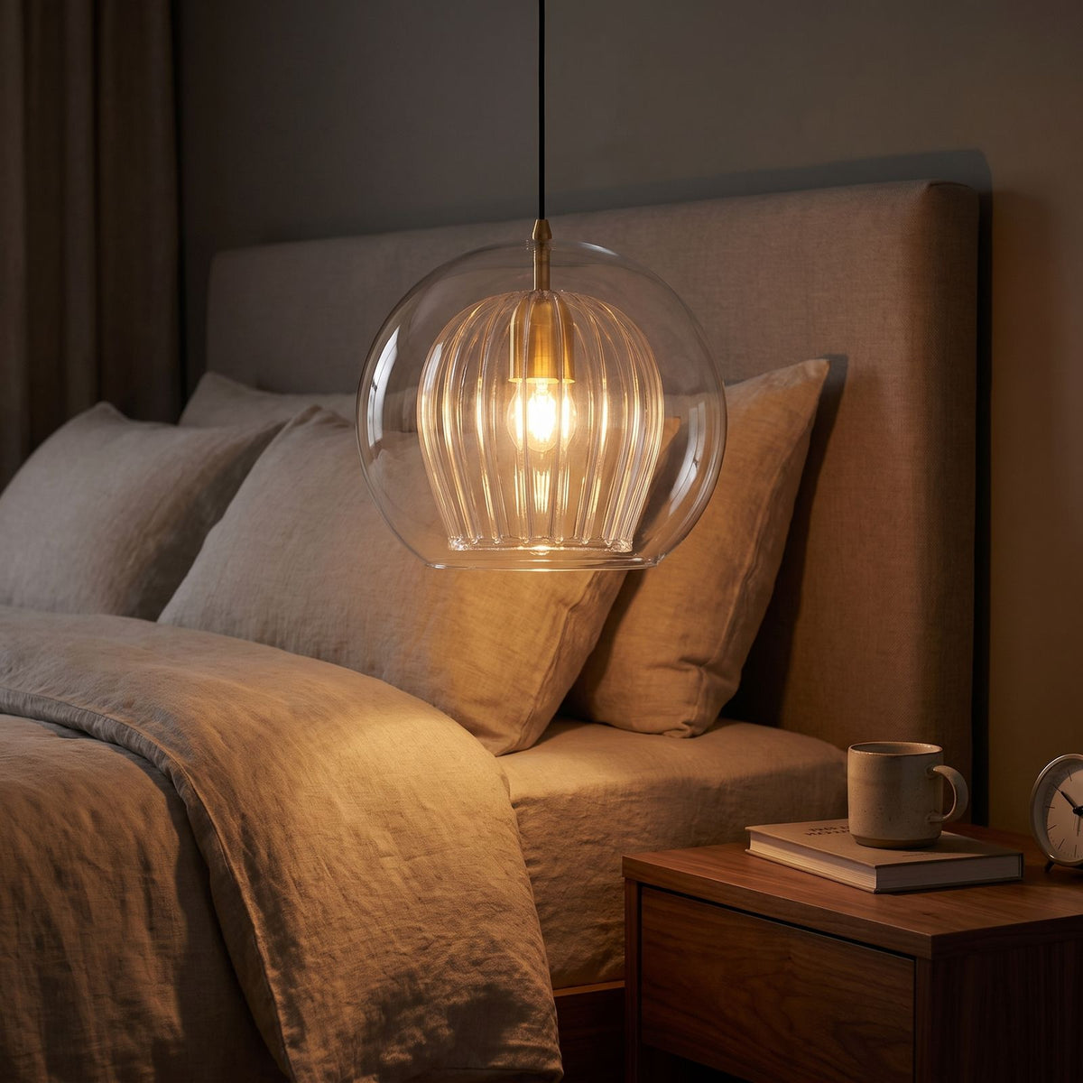Double glass fluted dome pendant light beside a bed as a bedside pendant