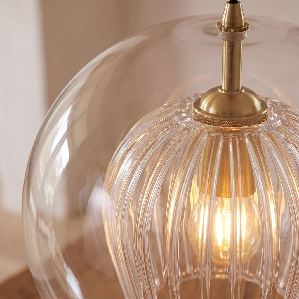 Close-up of the fluted inner glass shade and brass holder