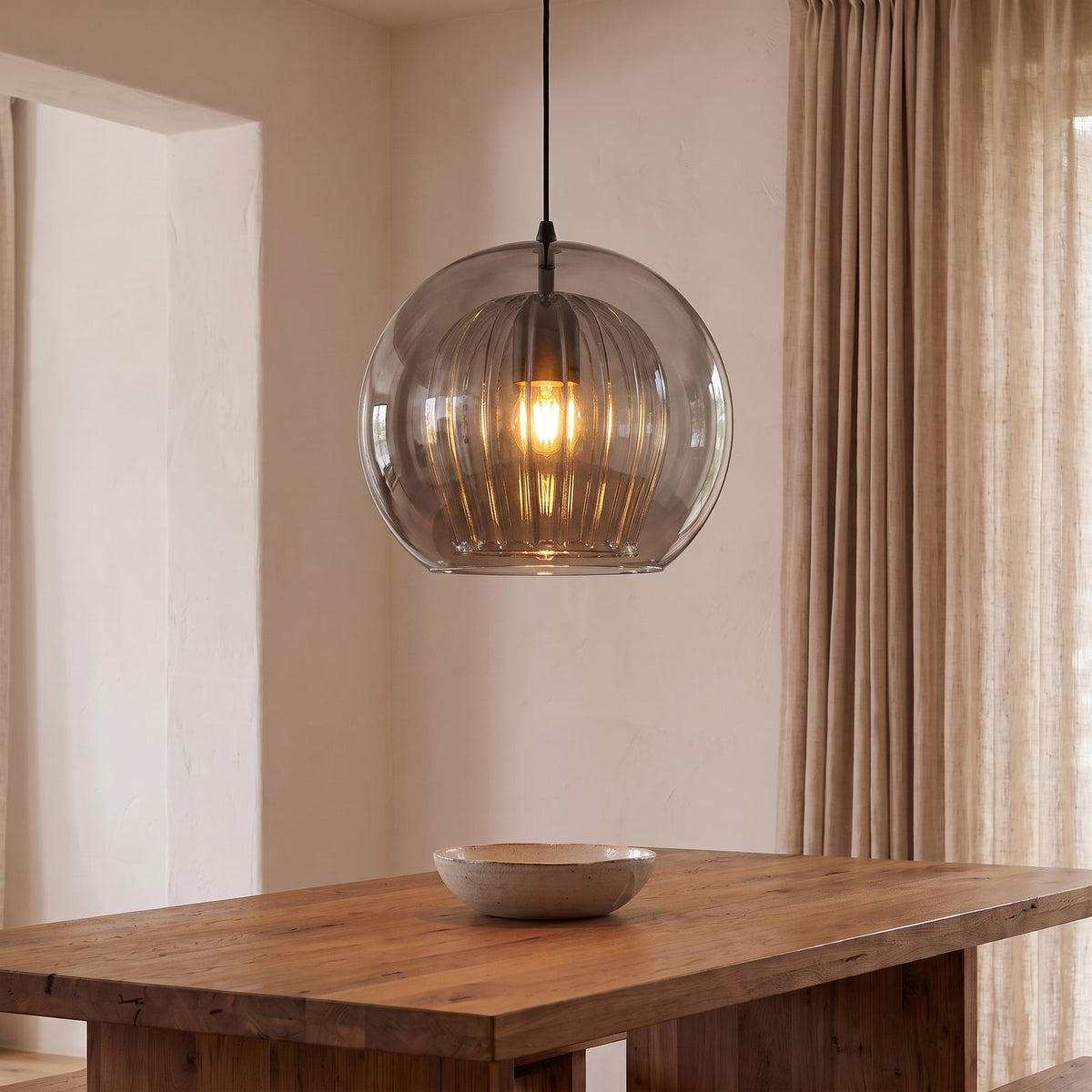 Double Glass Fluted Dome Pendant Light in smoky grey glass above a dining table