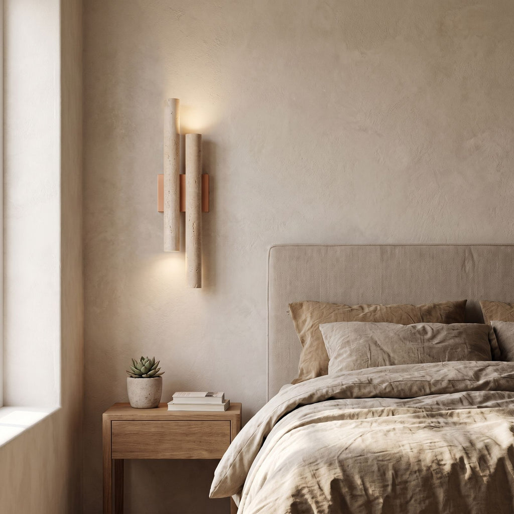 Double Travertine Column Wall Light on a bedroom wall beside the bed