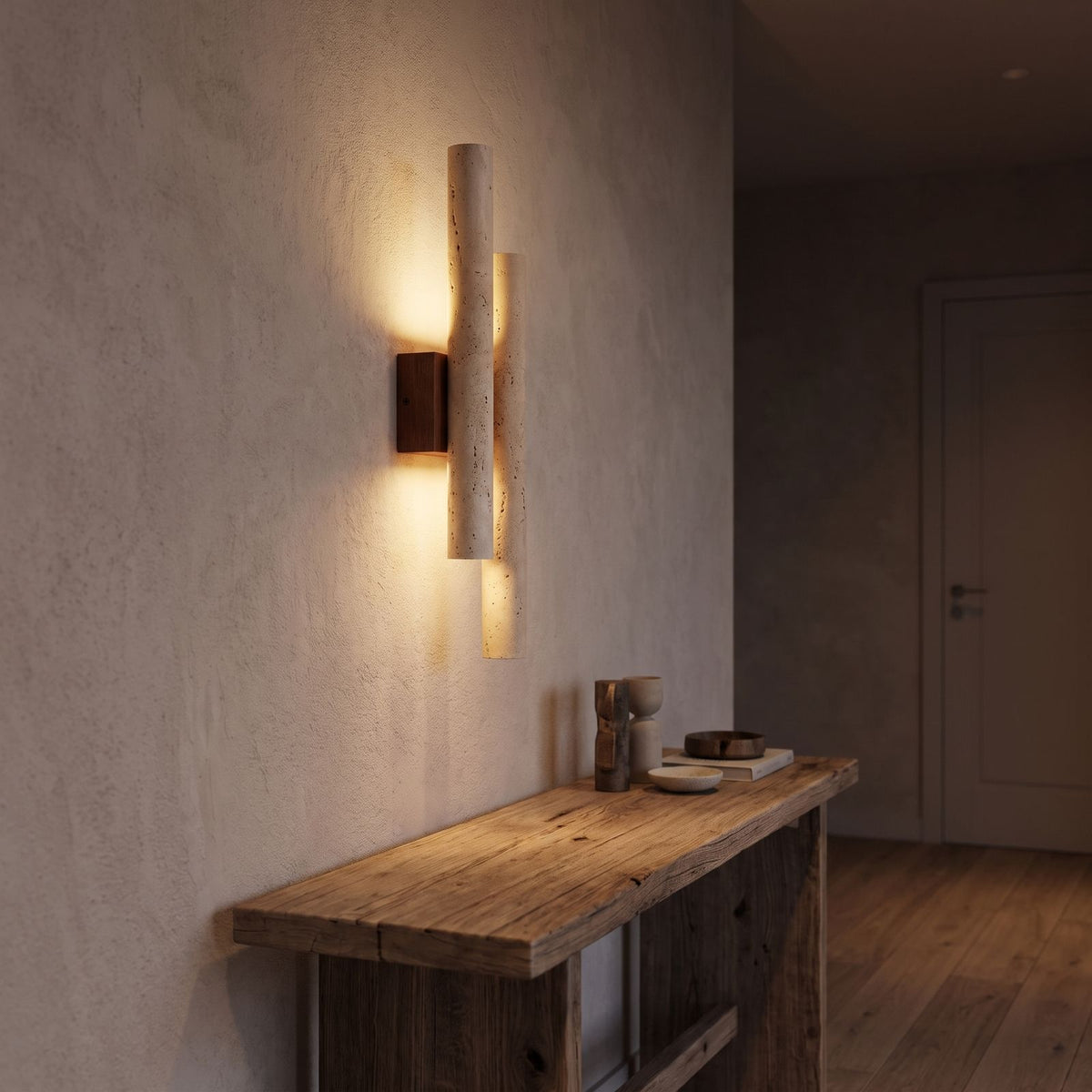 Double Travertine Column Wall Light in a hallway above a timber console