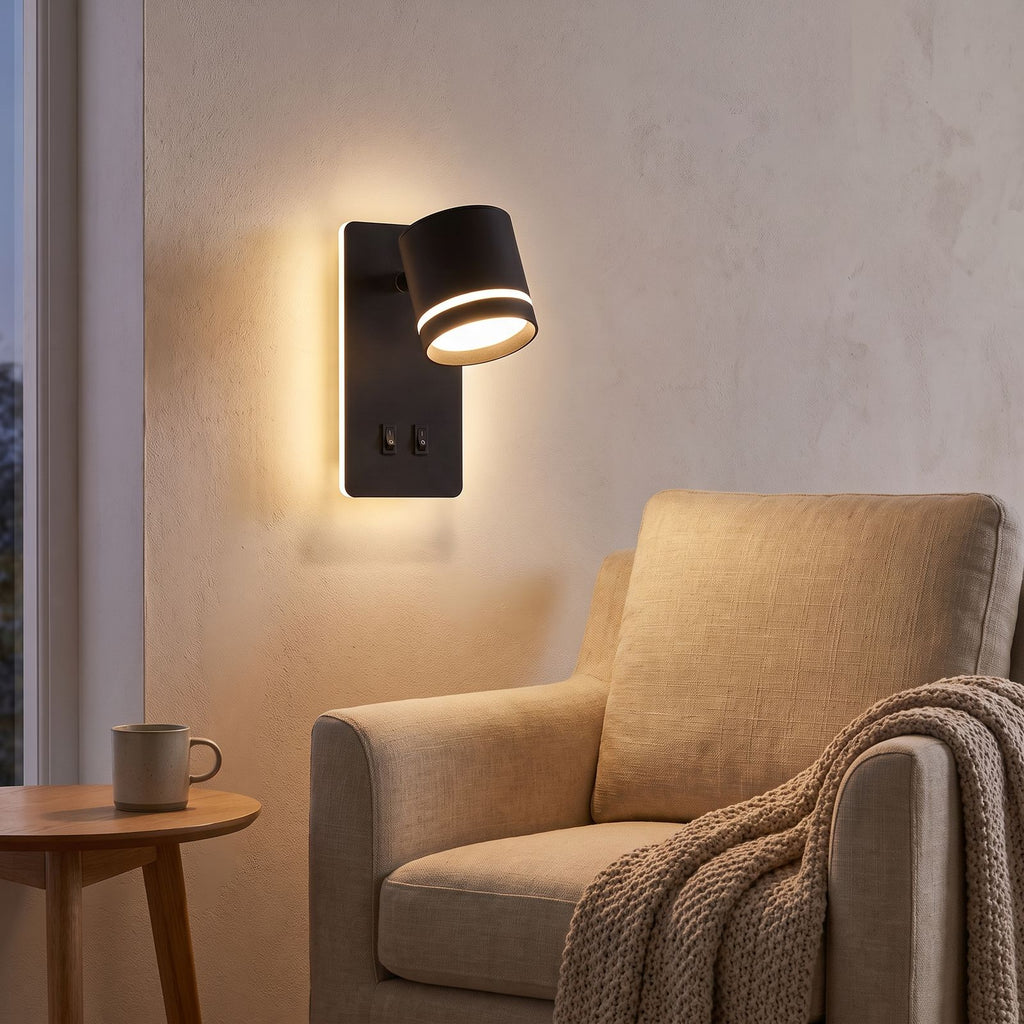 Backlit spotlight bedside wall light above an armchair in a reading corner