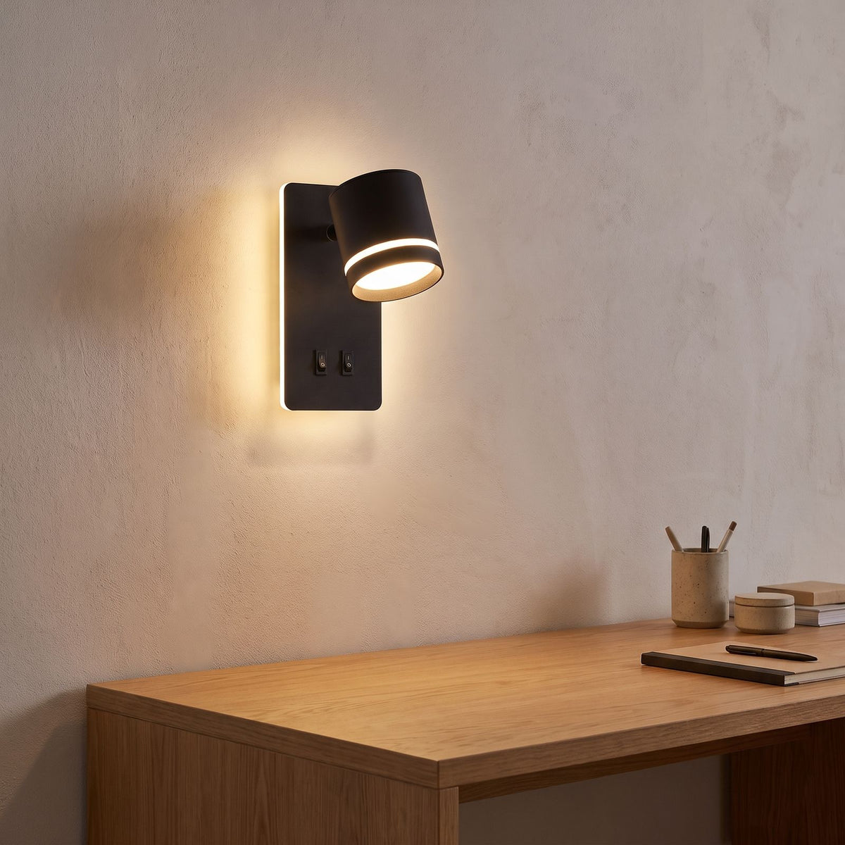 Backlit spotlight bedside wall light above a home office desk