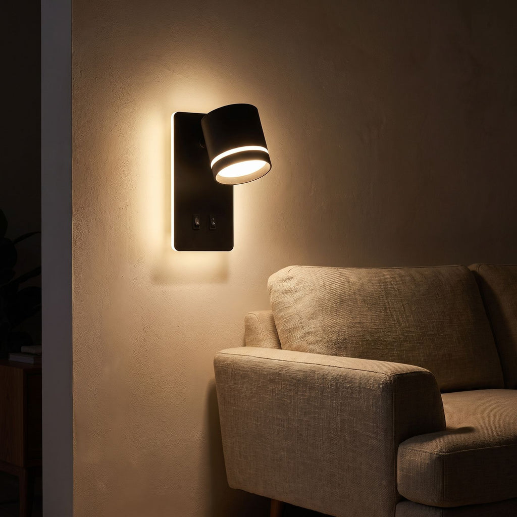 Backlit spotlight bedside wall light beside a living room sofa at night