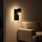 Backlit spotlight bedside wall light beside a living room sofa at night