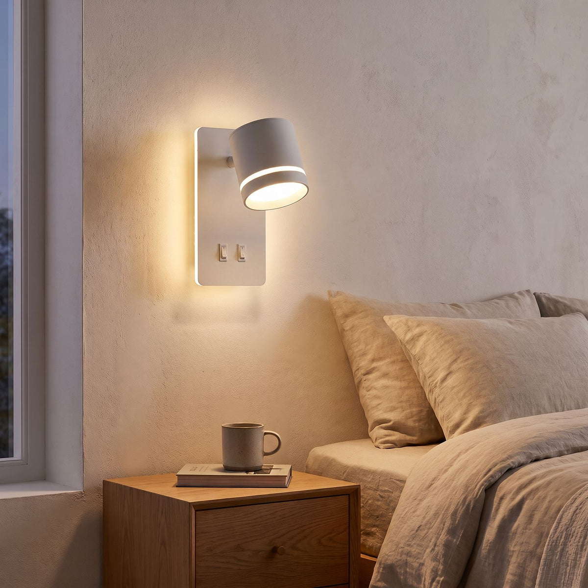 Dual Switch Backlit Spotlight Bedside Wall Light in white beside a bed