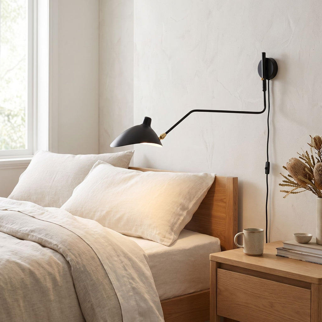 Duckbill Shade Adjustable Arm Wall Light on a bedroom wall beside the bed