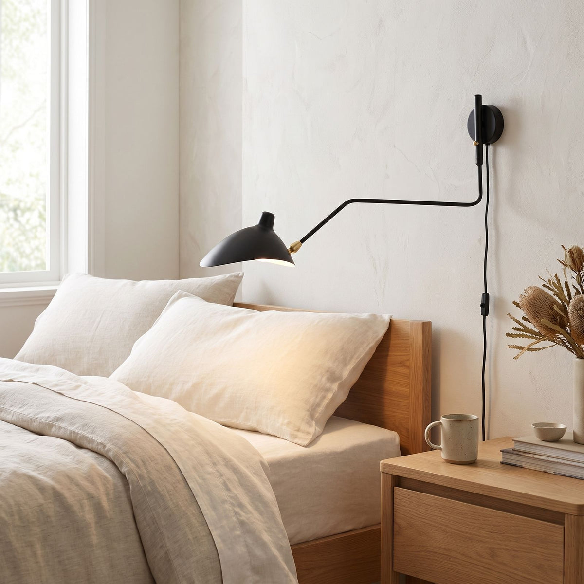 Duckbill Shade Adjustable Arm Wall Light on a bedroom wall beside the bed