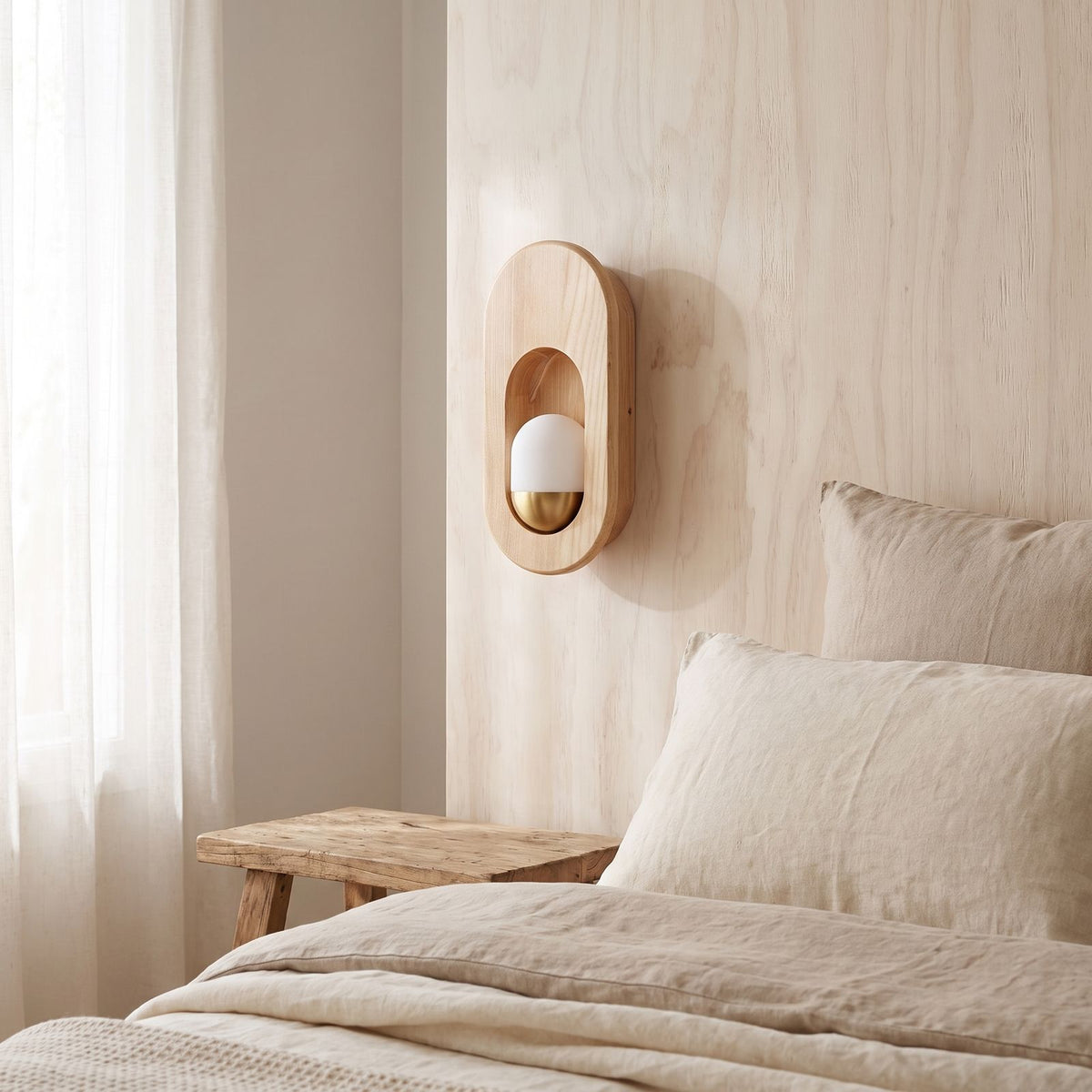 Egg-Shaped Wood and Acrylic Wall Light on a bedroom wall beside the bed