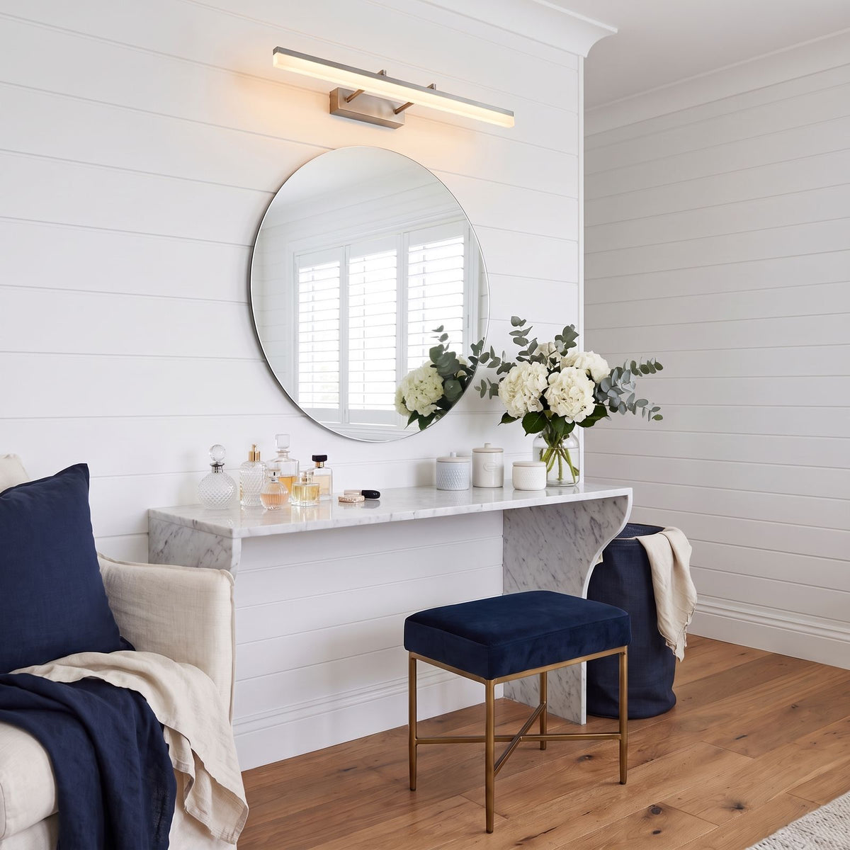 Extendable Dual Rod Stainless Steel LED Vanity Wall Light in silver, above the mirror of a dressing table