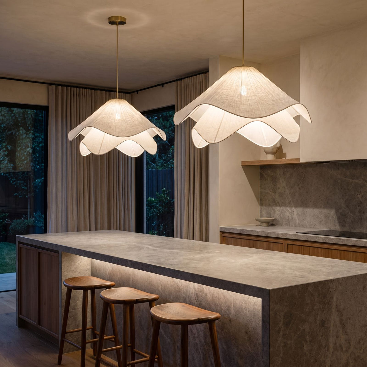 A pair of Fabric Petal Japandi Pendant Lights over a stone kitchen island