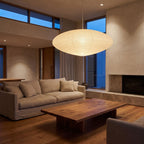 Faceted Mulberry Paper Pendant Light above a linen sofa in a living room