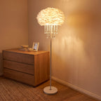 Feather shade crystal drop floor lamp in a bedroom corner beside a dresser