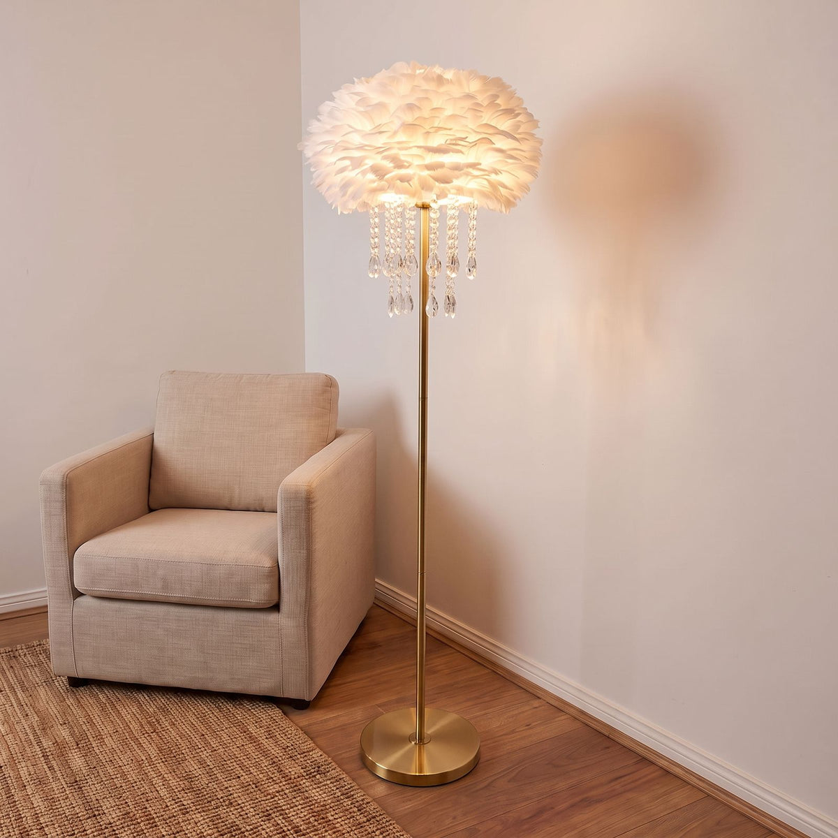 Feather Shade Crystal Drop LED Floor Lamp with a brass finish body beside an armchair in a living room corner