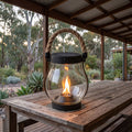 Flame Effect Jar Lantern Solar Garden Light on an outdoor dining table at dusk