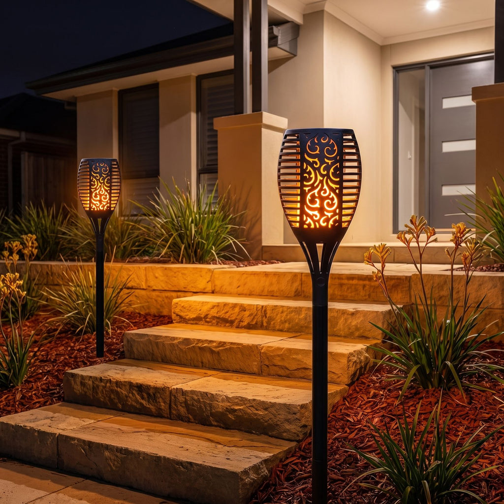 Flame effect solar garden torch either side of front steps at night