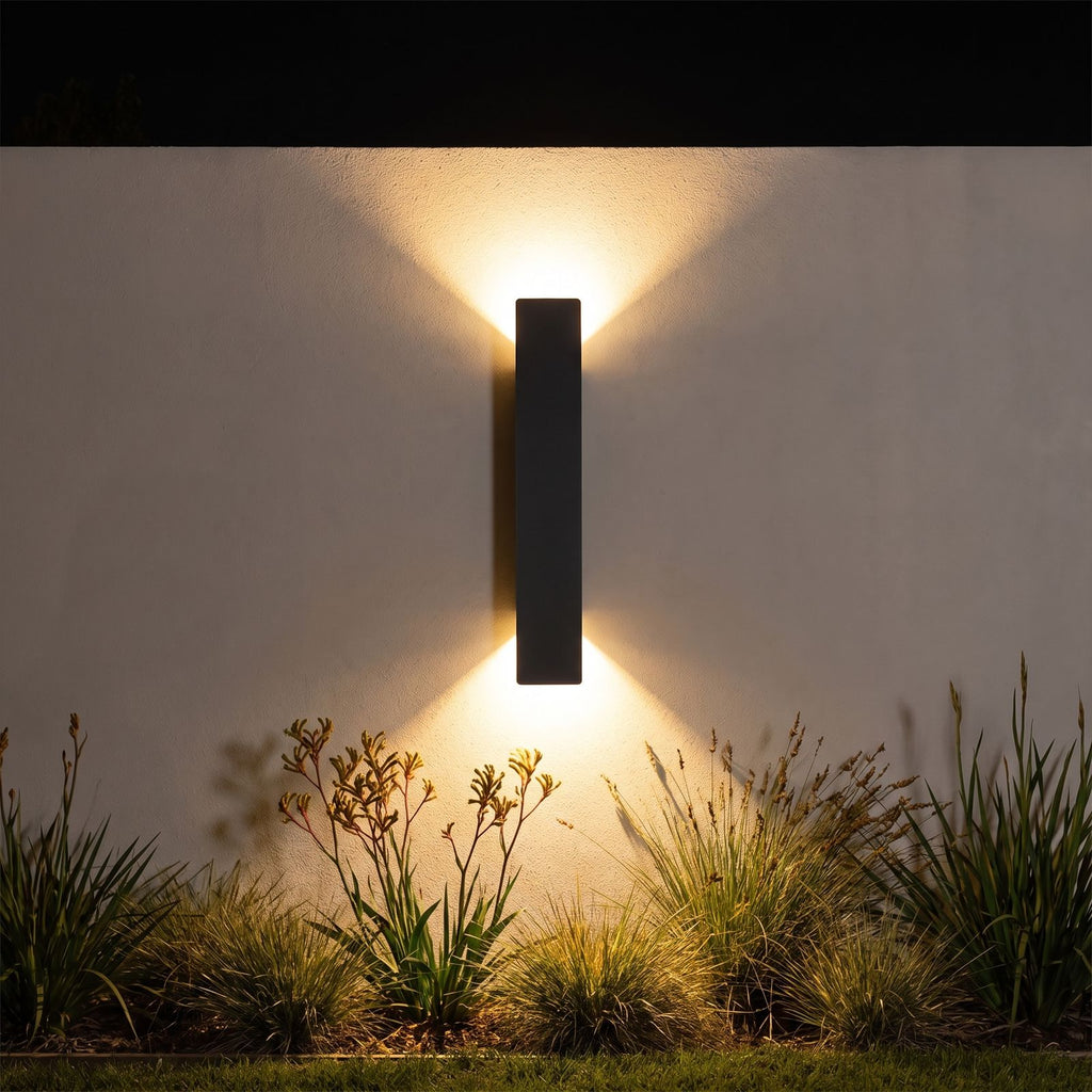 Flat bar up down outdoor wall light on a garden wall at night
