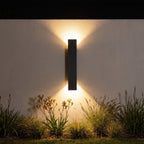 Flat bar up down outdoor wall light on a garden wall at night