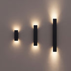 Flat Bar Aluminium Up Down Outdoor Wall Lights in black in the three lengths, 20.5, 41 and 61 cm, side by side on a rendered wall