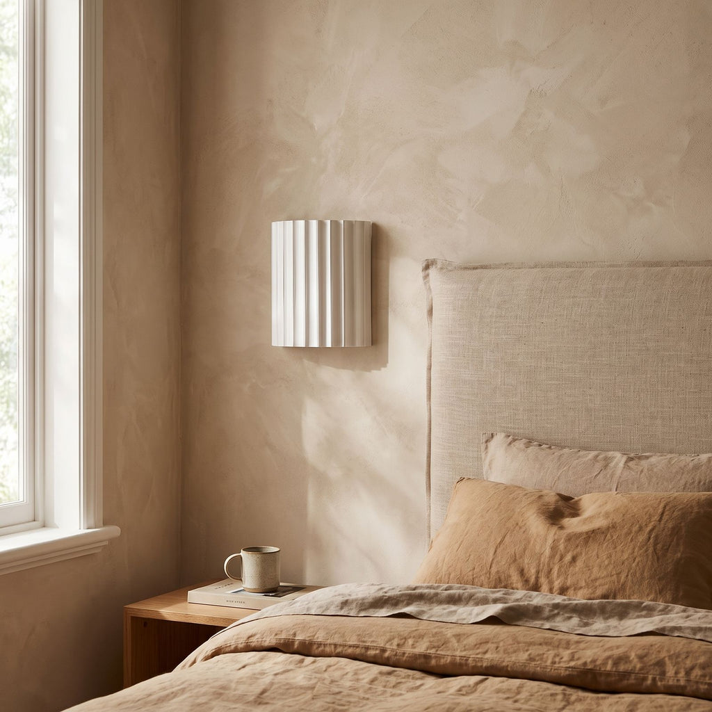 Fluted Resin Wall Light on a bedroom wall beside the bed