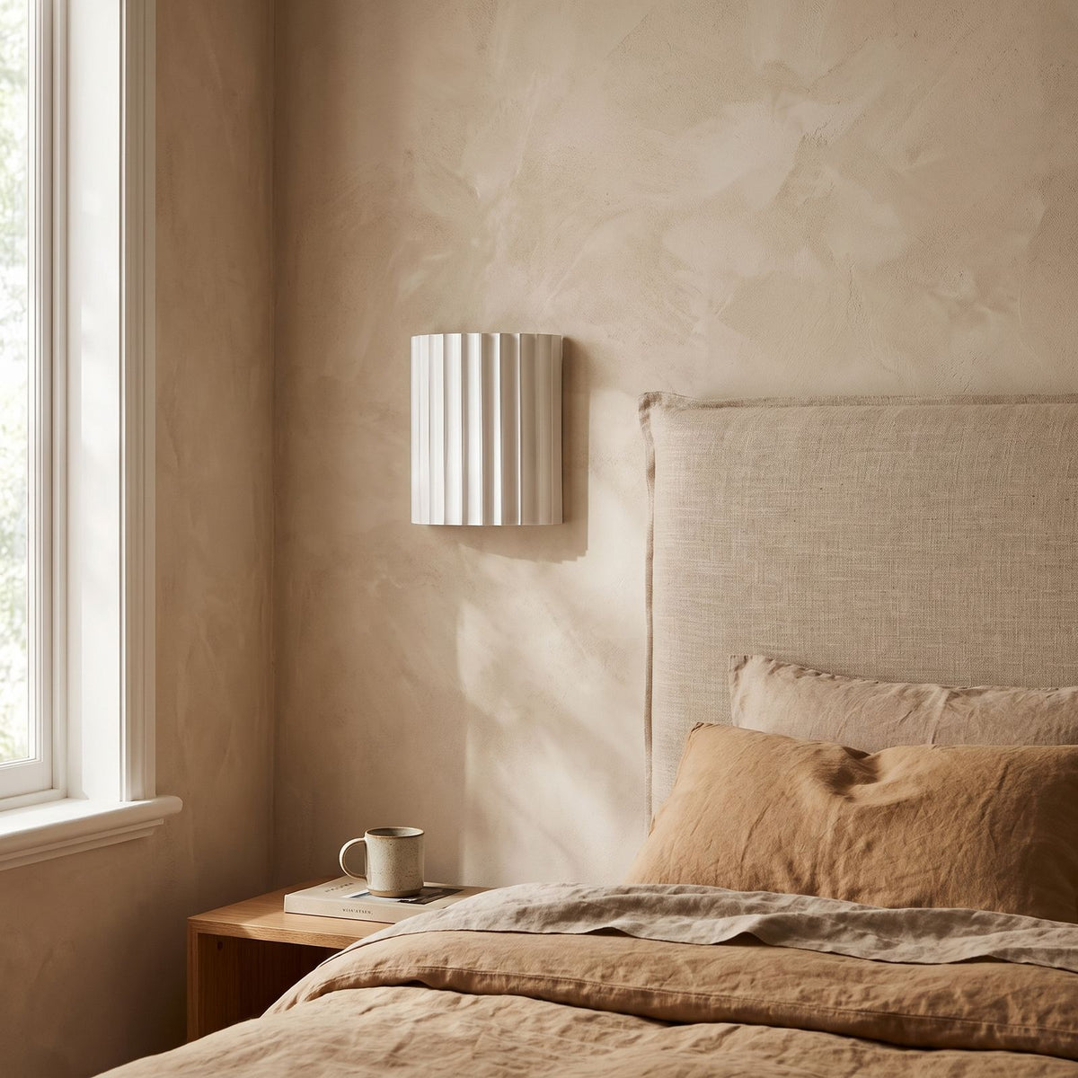 Fluted Resin Wall Light on a bedroom wall beside the bed