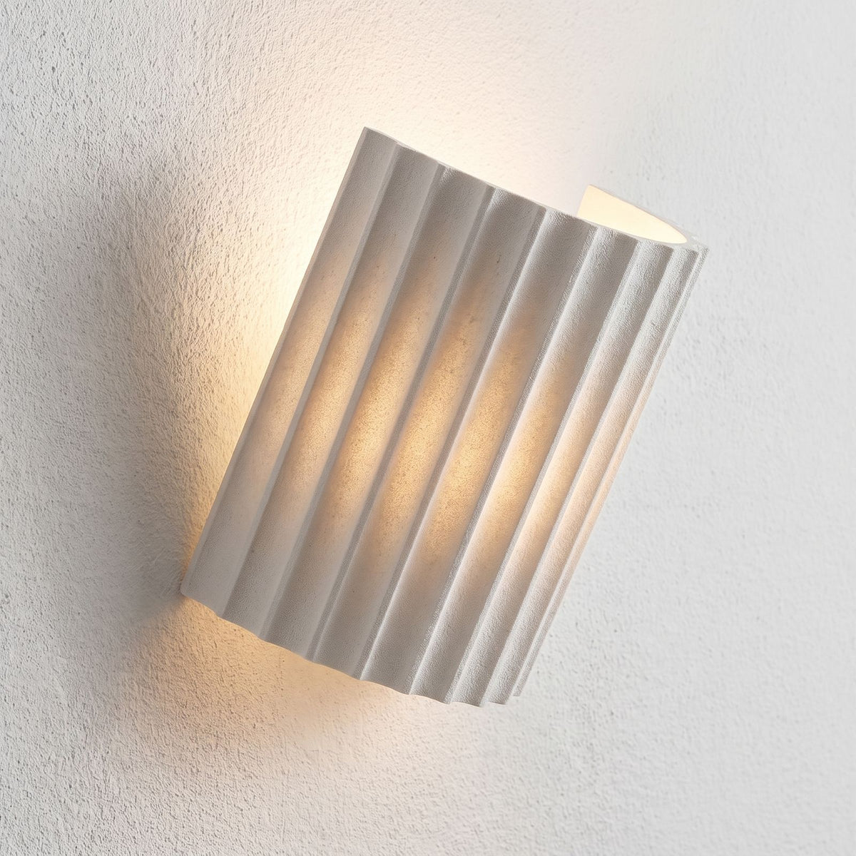 Fluted Resin Wall Light, close view at 45 degrees on a plaster wall