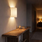 Fluted Resin Wall Light in a hallway above a timber console