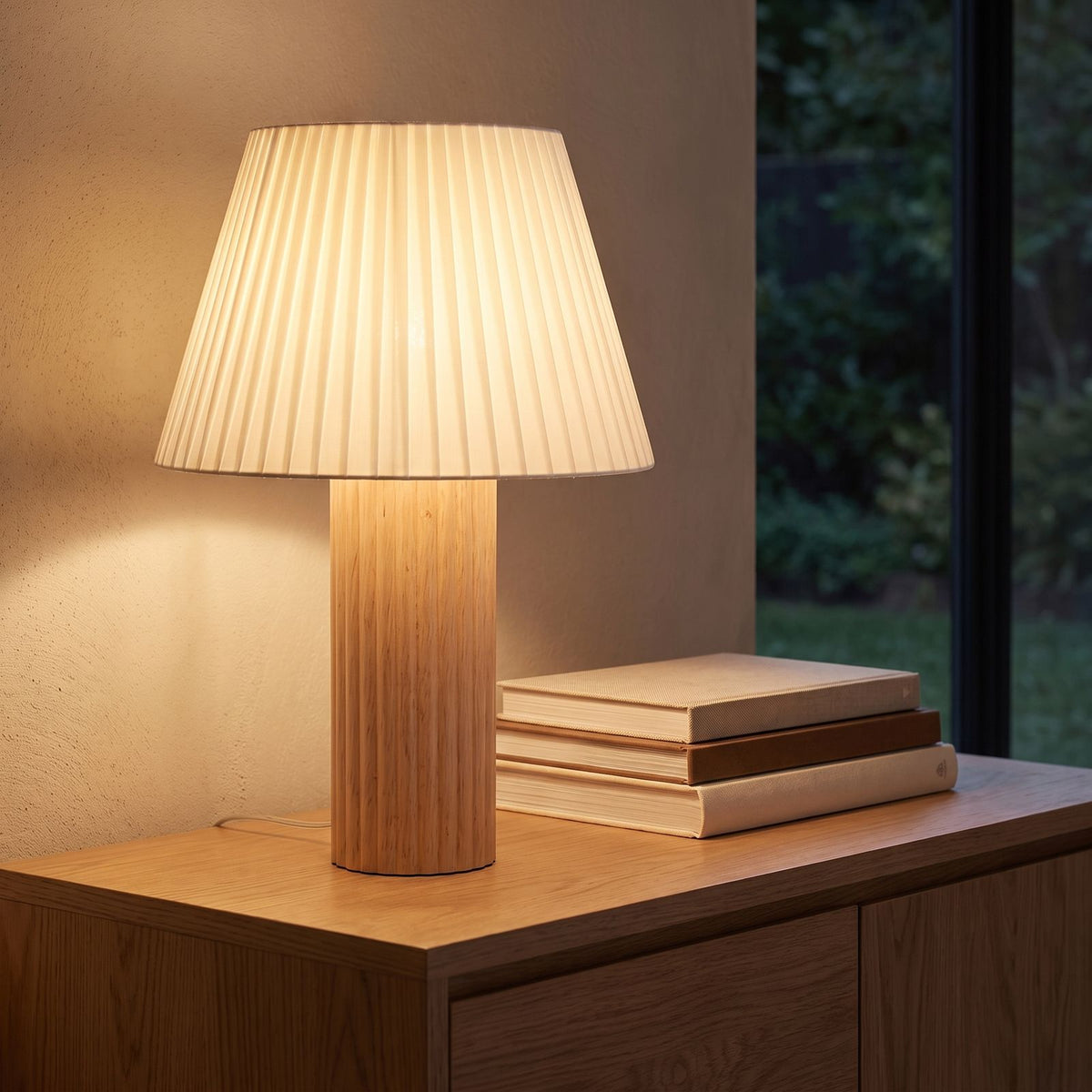 Fluted wood pleated shade table lamp on a living room sideboard