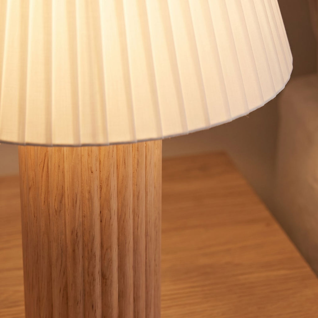 Close-up of the fluted wood column and pleated shade