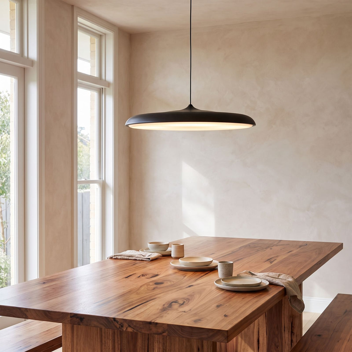 Flying Saucer LED Pendant Light above a timber dining table