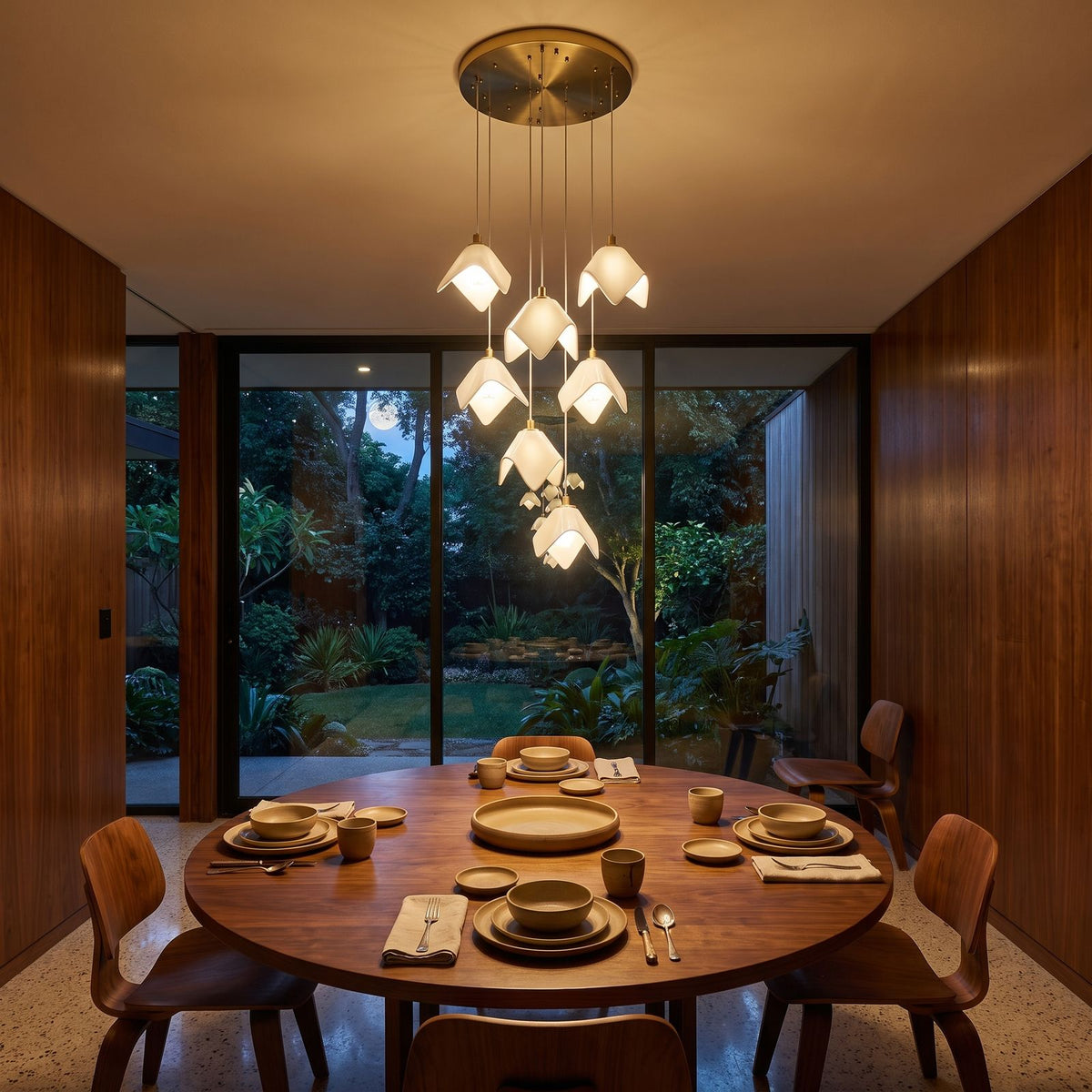 Folded Ceramic Petal Cluster Chandelier above a round dining table at night