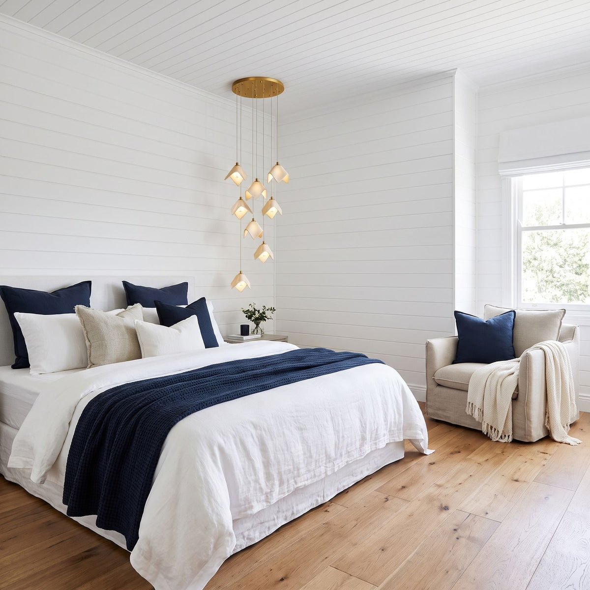 Folded Ceramic Petal Cluster Chandelier beside a bed in a main bedroom in daylight