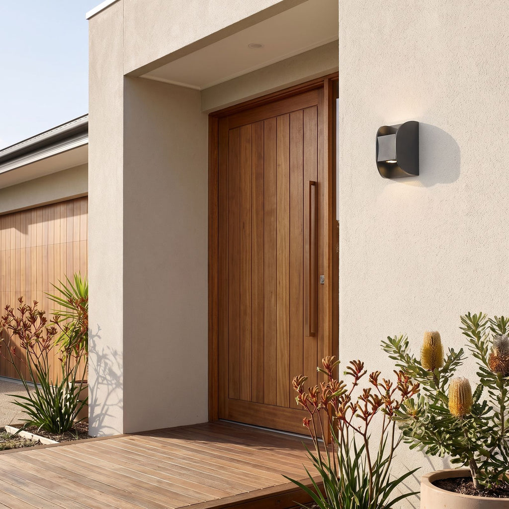 Forged Metal Mini Up Down Outdoor Wall Light beside a timber front door