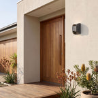 Forged Metal Mini Up Down Outdoor Wall Light beside a timber front door