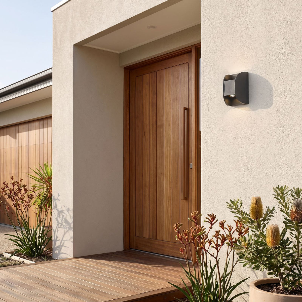 Forged Metal Mini Up Down Outdoor Wall Light beside a timber front door