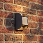 Forged Metal Mini Up Down Outdoor Wall Light, close view at 45 degrees on a stone wall