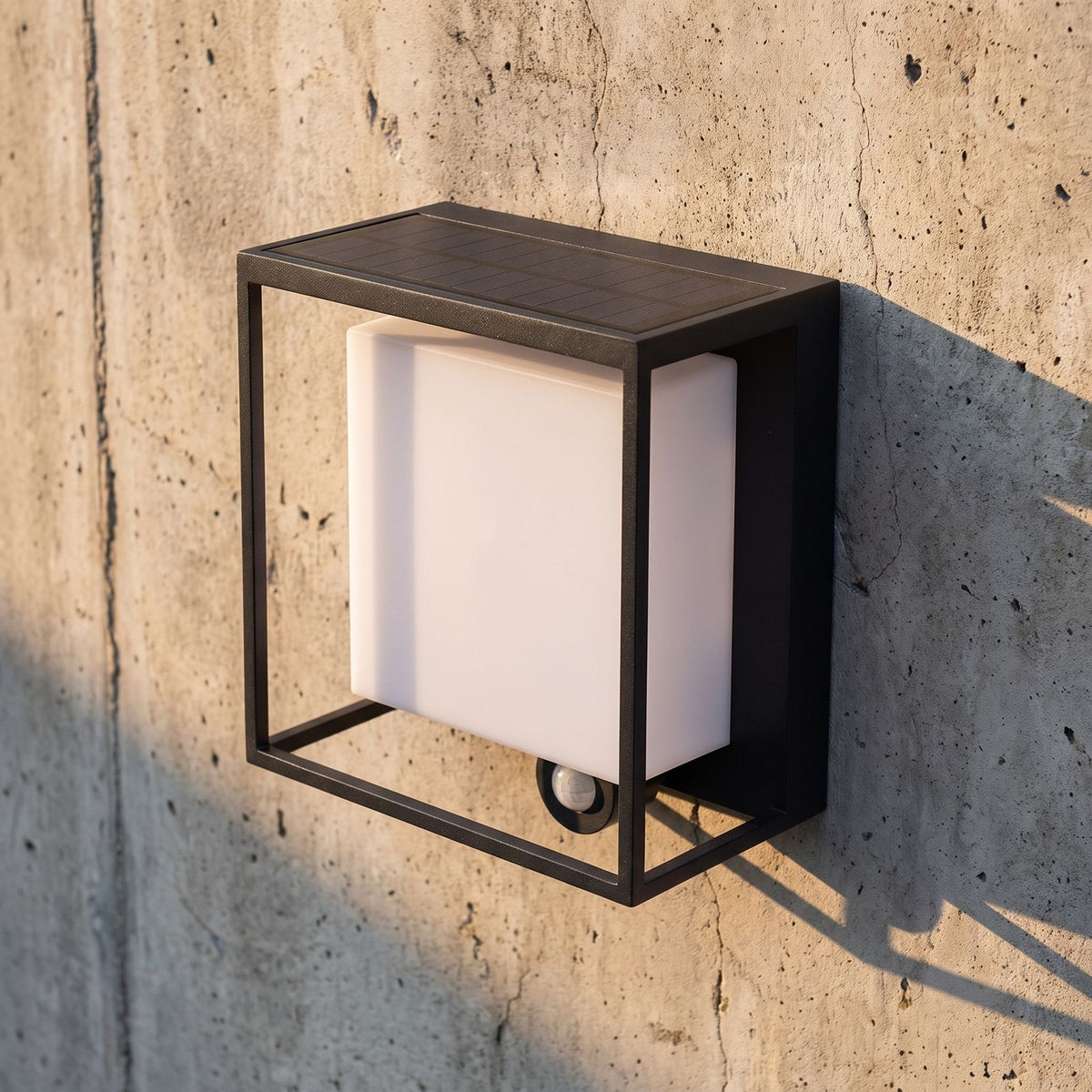 Framed Acrylic Solar Sensor Outdoor Wall Light, close view at 45 degrees on a stone wall