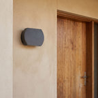 Geometric Glass Up Down Outdoor Wall Light beside a timber front door