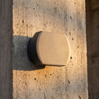 Geometric Glass Up Down Outdoor Wall Light, close view at 45 degrees on a stone wall