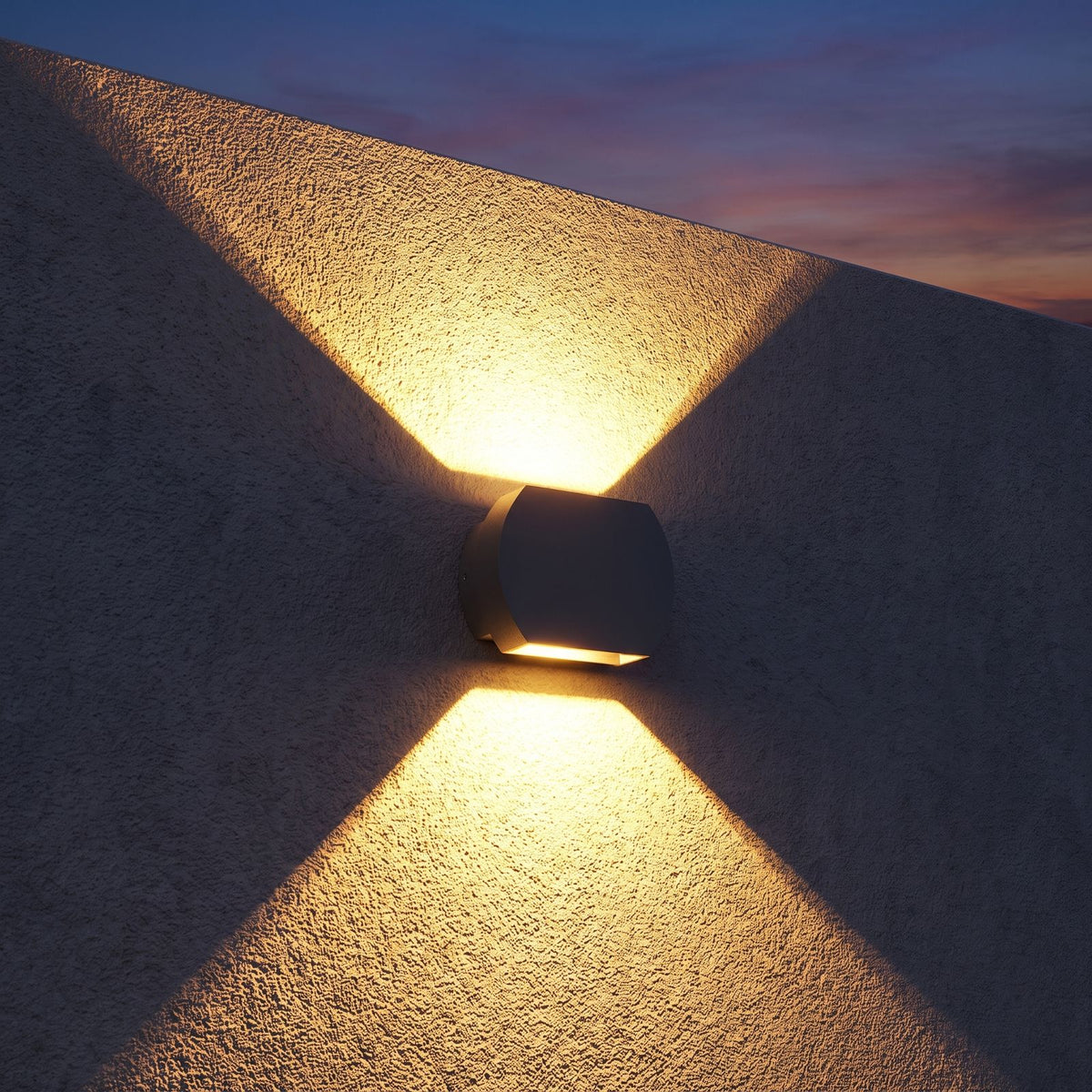 Geometric Glass Up Down Outdoor Wall Light on a porch wall at dusk