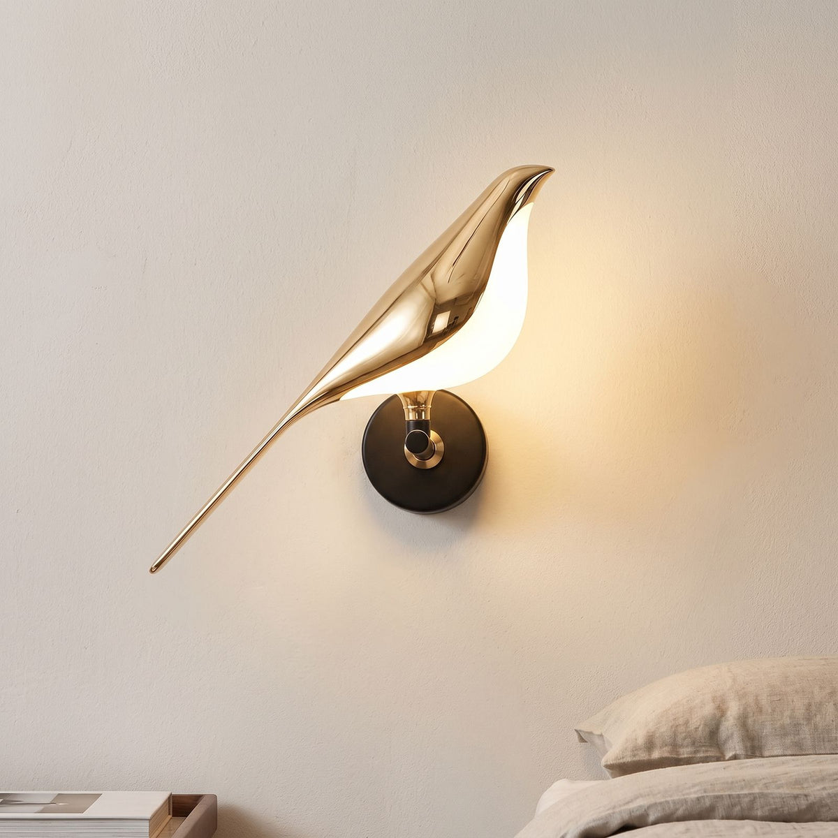 Gold Bird Sculpture LED Wall Light beside a bed