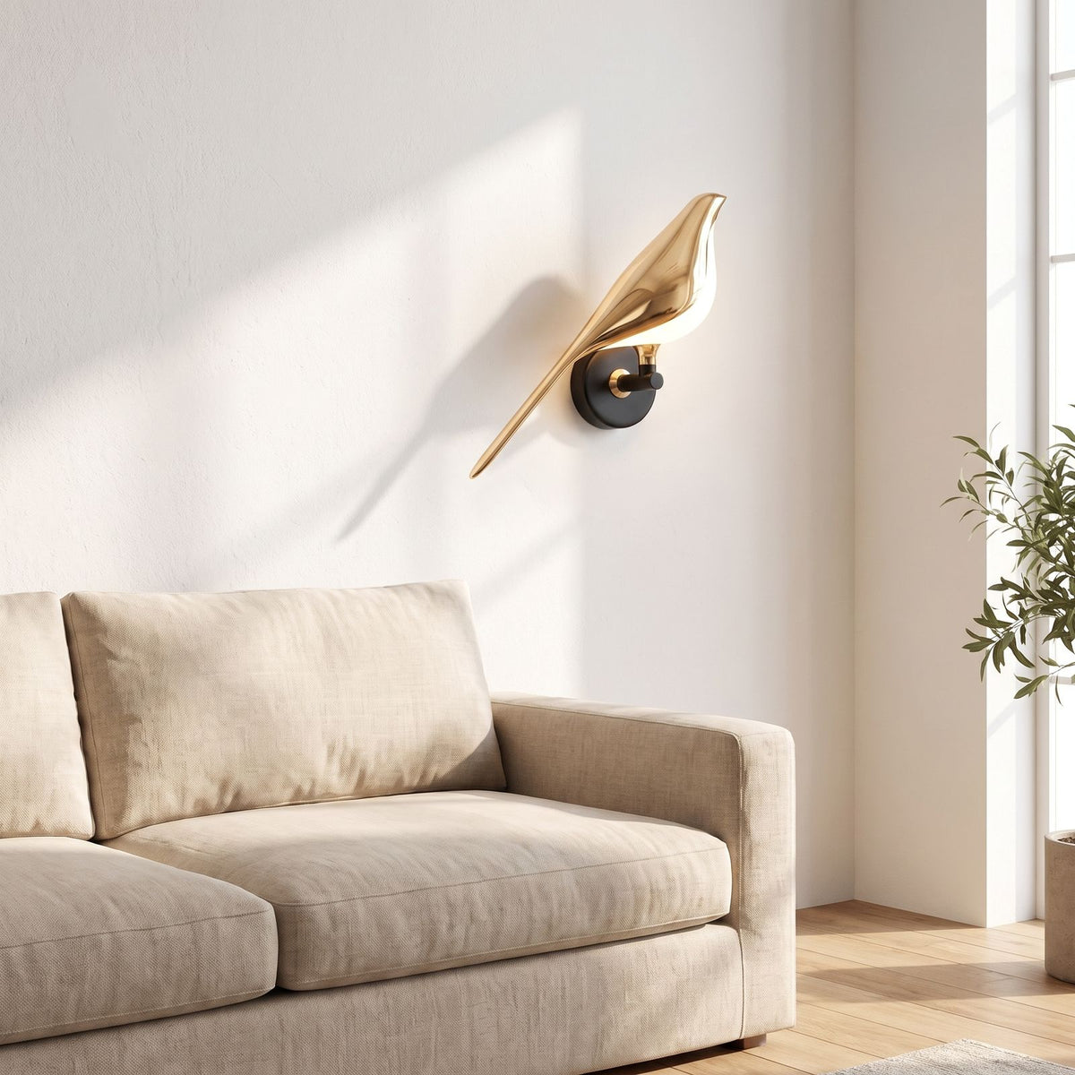 Gold bird sculpture LED wall light beside a living room sofa in daylight