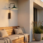 Green Cone Shade Outdoor Wall Light above timber bench seating at golden hour