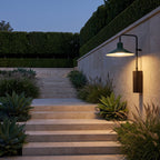 Green Cone Shade Outdoor Wall Light above stone garden steps at dusk